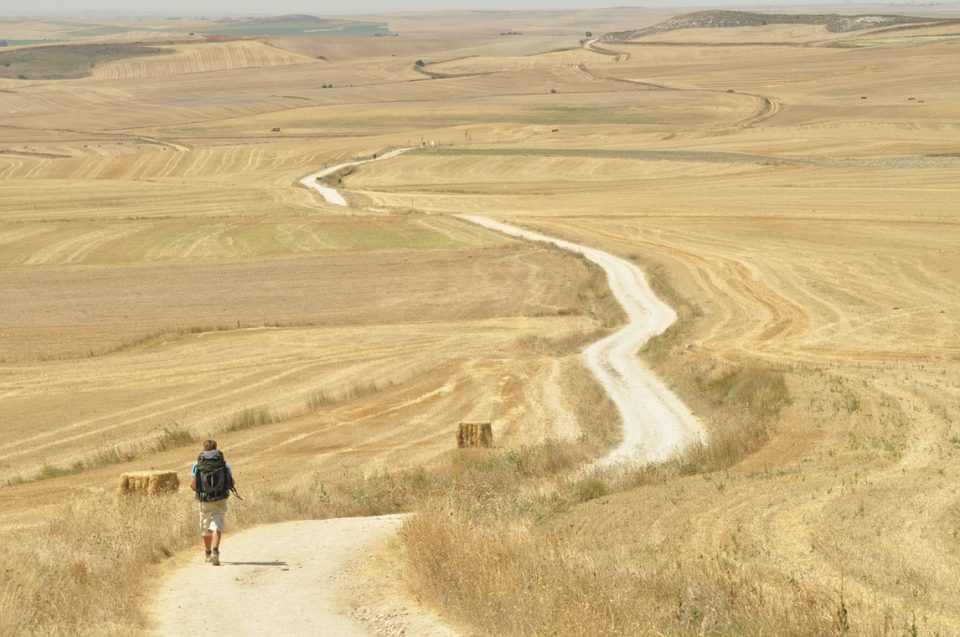 Hiker on dry arid Camino trail