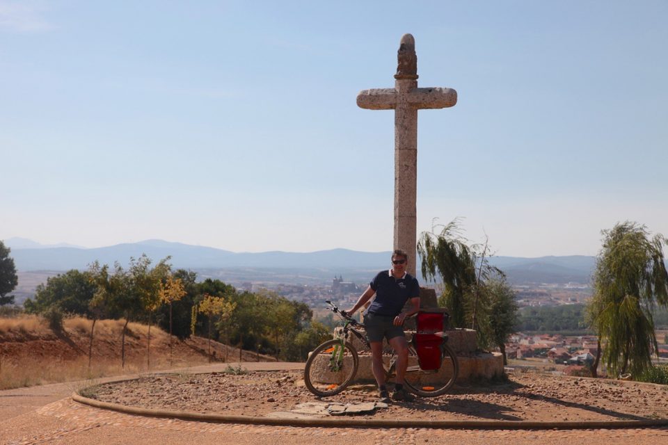 Cyclist on Camino stopped at religious cross