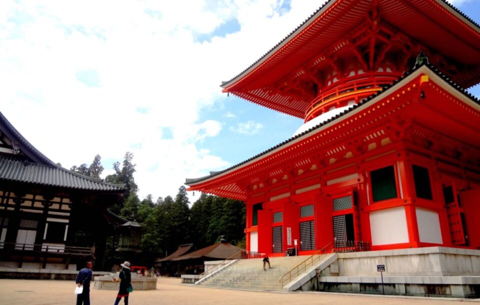 Koyasan temple bright red temple towering over the courtyard.