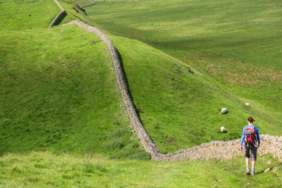 Hiker next to Hadrian's wall