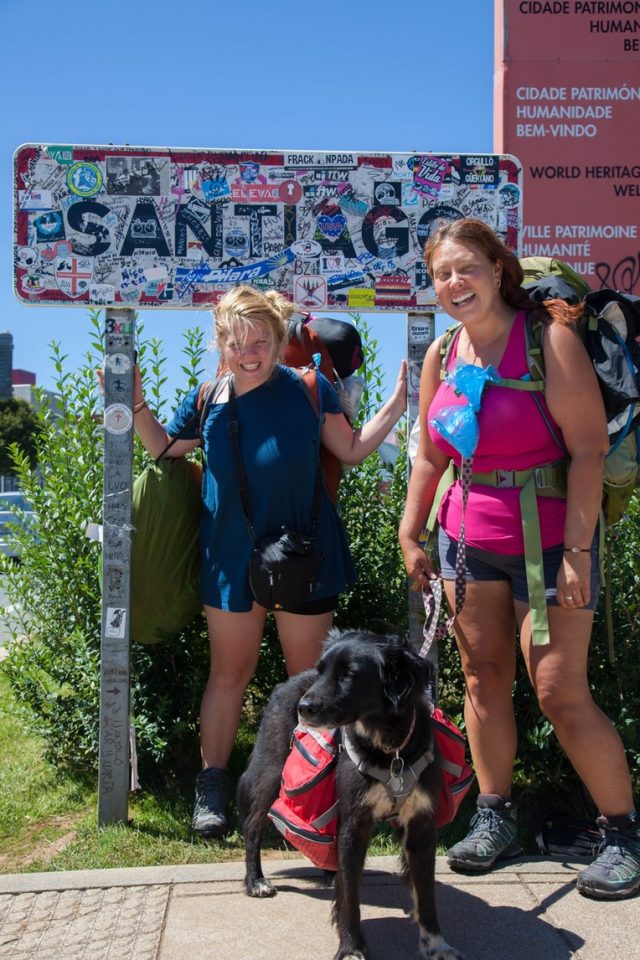 Walkers standing in front of sign along Camino