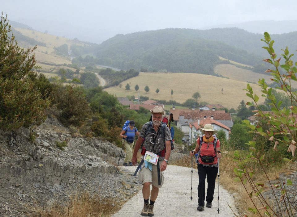 Hikers walking towards camera on Camino path