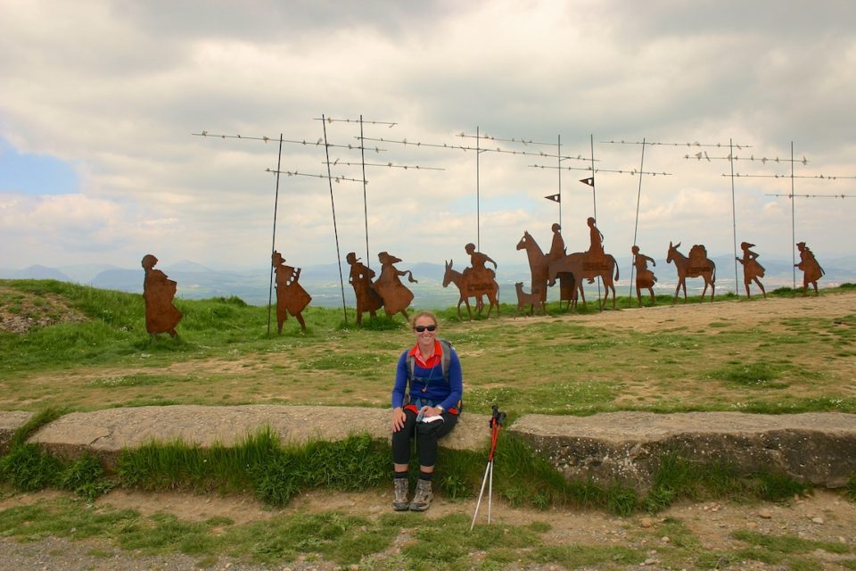 Hiker sitting in front of Camino Art installation