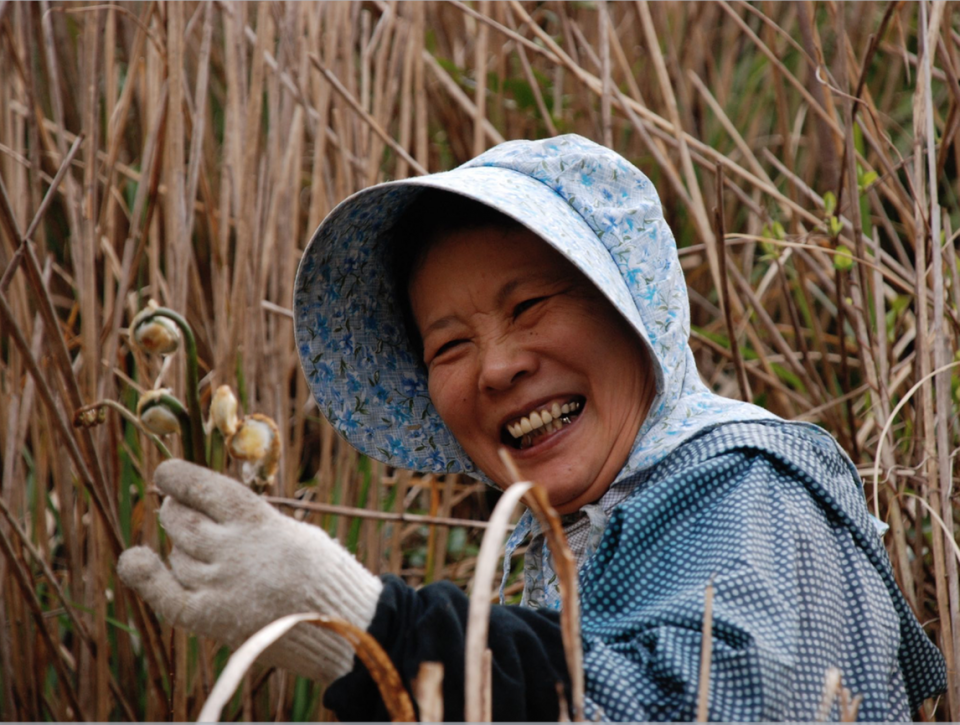 Local villager laughing in the fields. Japan.