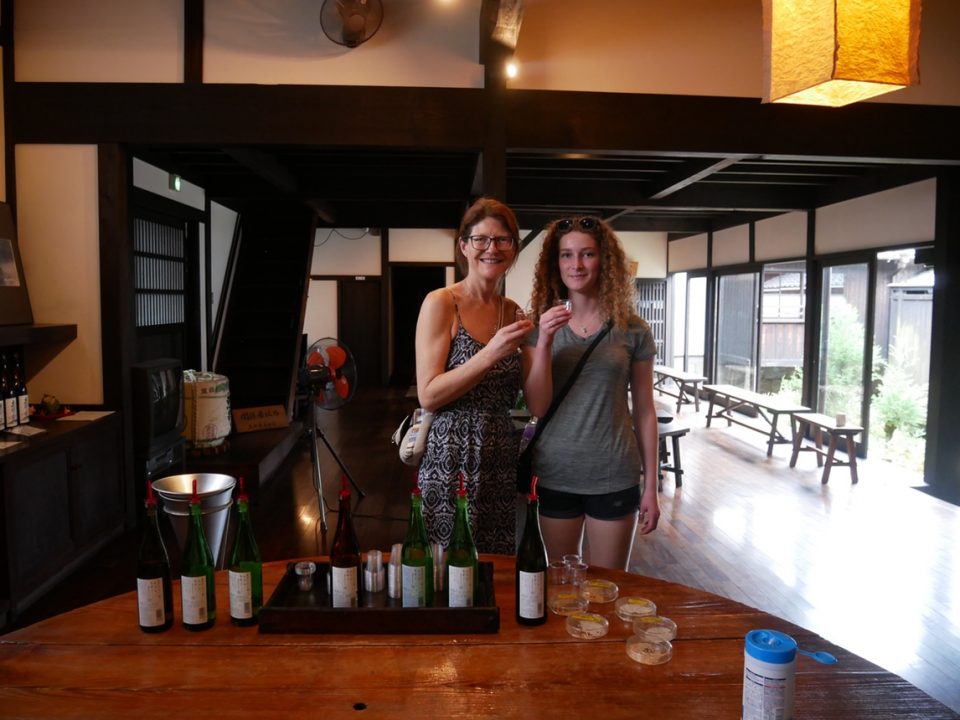 Hikers enjoying night after a long days hike. Standing inside a Japanese restaurant.