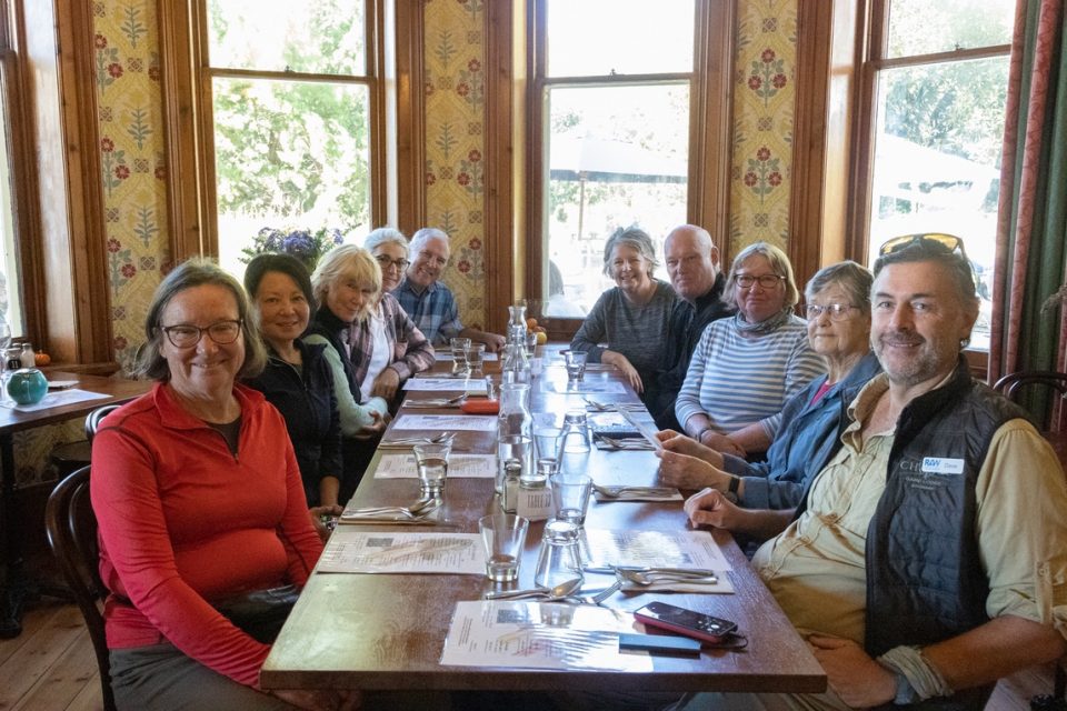 Hikers sitting down to eat a meal together after a day hiking