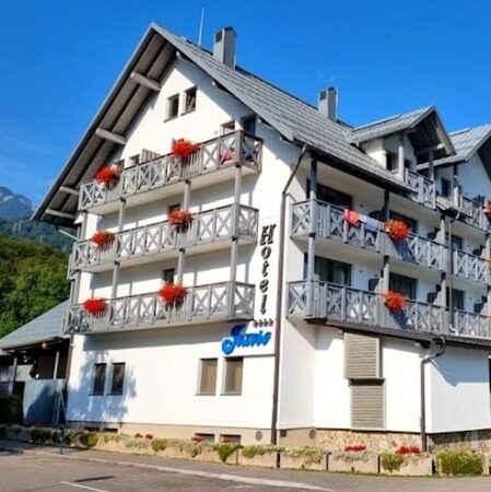 Exterior of a traditional whitewashed hotel in Slovenia near Lake Bohinj