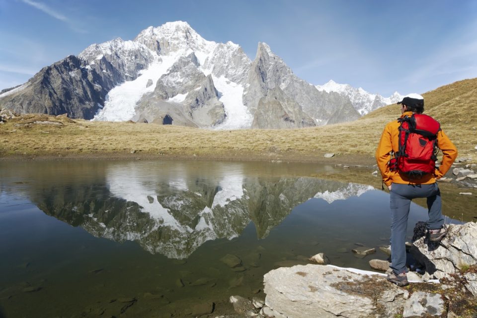 Male hiker enjoying the view over the beautiful landscape of Mont Blanc, Courmayeur, Italy