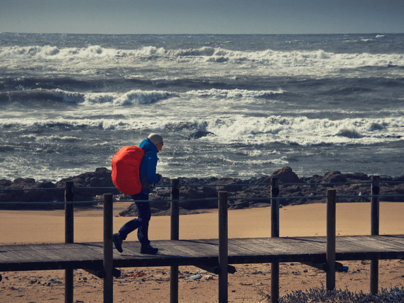 camino hiker with rough seas in the background
