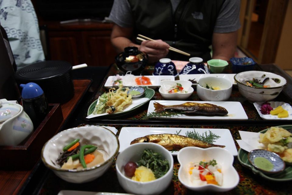 Traditional Japanese table with many dishes of delicious food