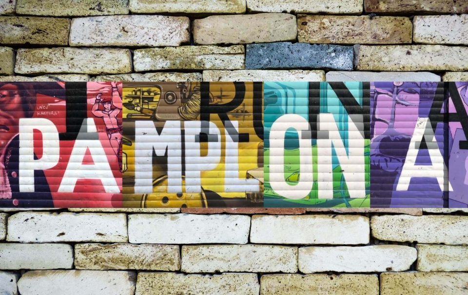 Colourful Pamplona street art on a brick wall.