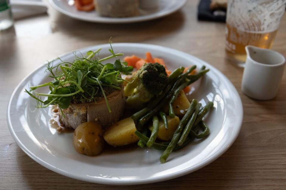 Closeup of a Scottish dinner of meat, carrots and potatoes on a plate.
