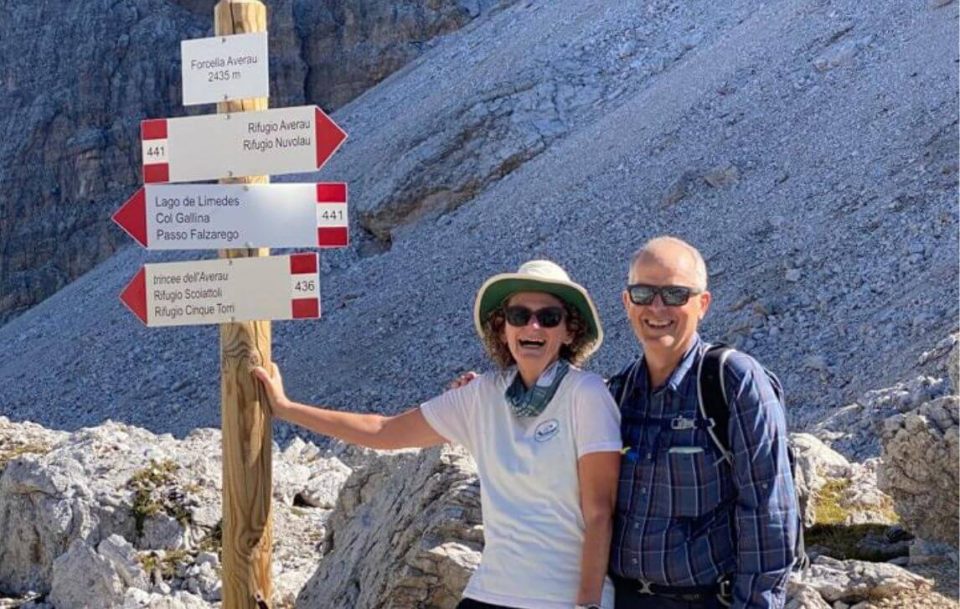 Walkers standing next to a sign post on Dolomites trek