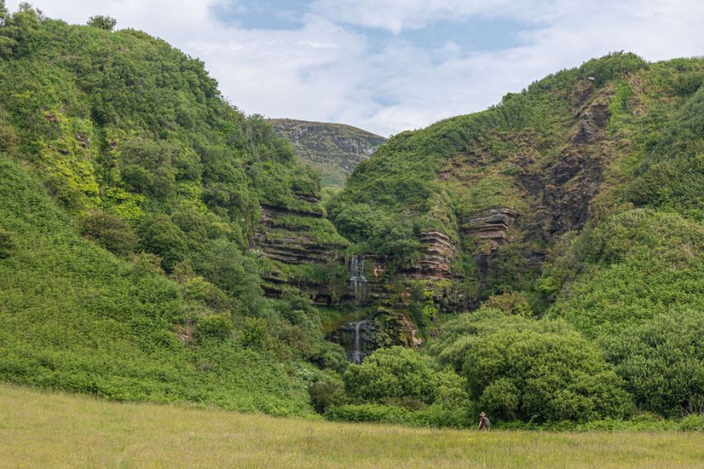 Two cascading waterfalls known as the Glenashdale Falls on the Isle of Arran in Scotland.