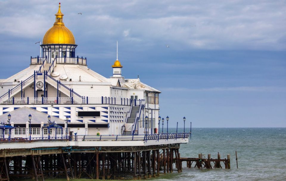 White building at the end of a traditional English seaside pier