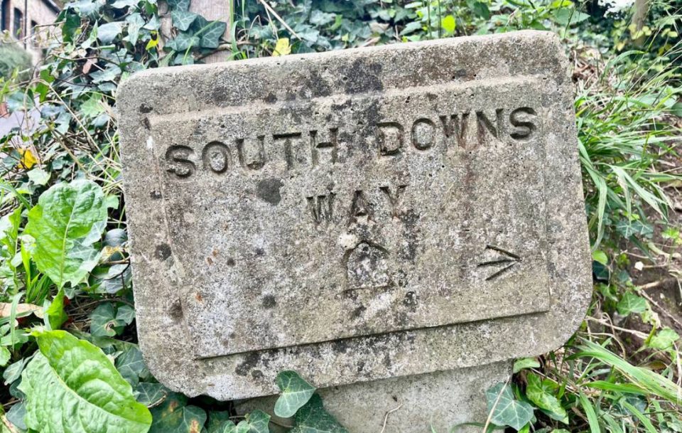 South Downs Way stone signpost, marking the scenic hiking trail.