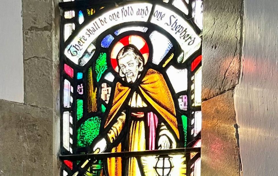 Intricately designed stained glass artwork of St. Peter, with vibrant hues and intricate patterns.