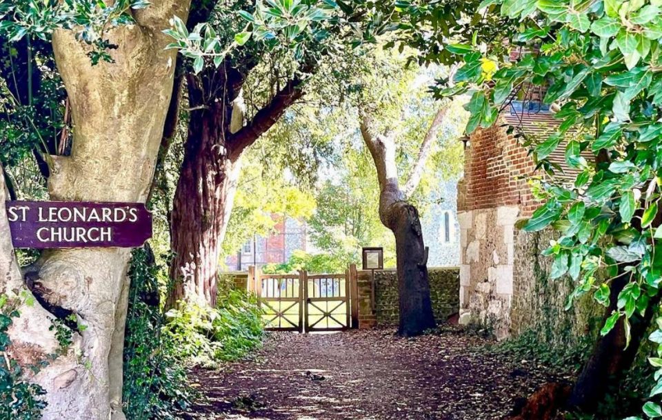 St Leonard's Church sign amidst a wooded area,