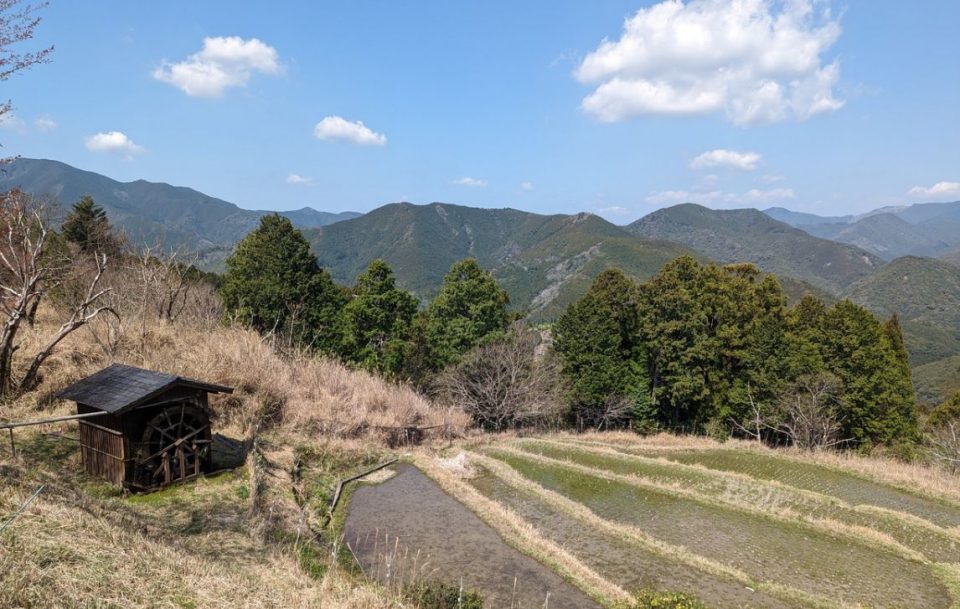 Hillside hut with scenic view of rice fields and mountains