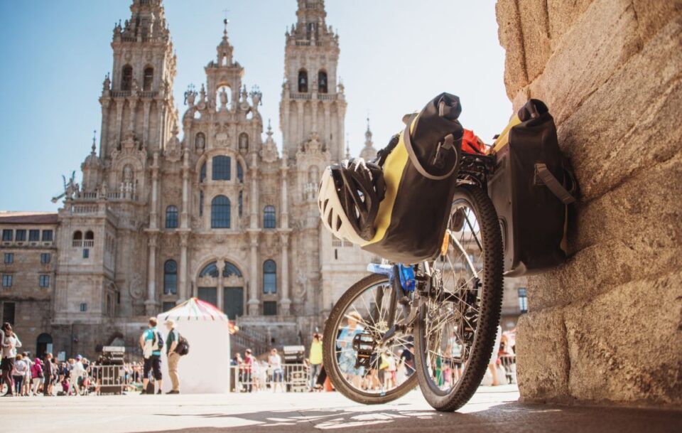 bike leaning against wall with Cathedral Santiago in back ground