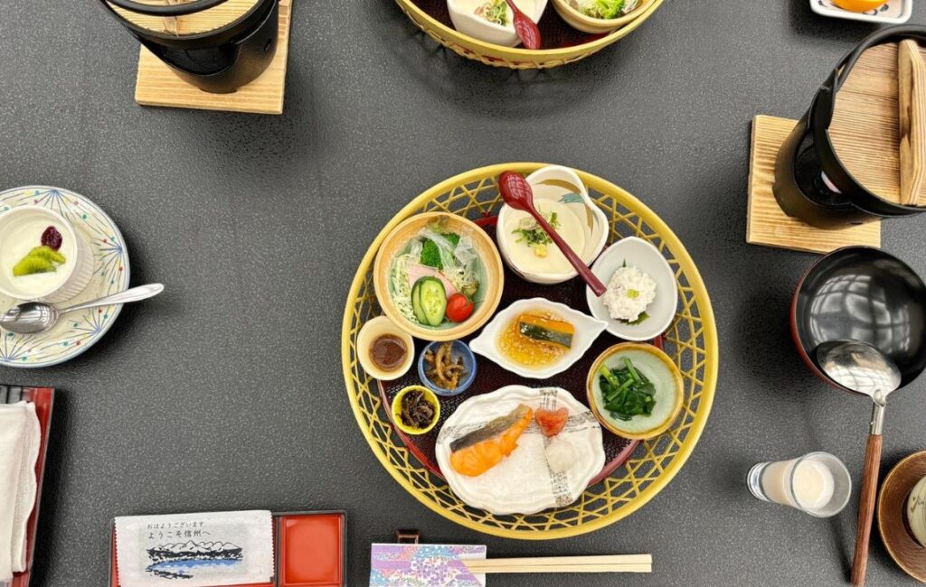 A plat of delicious Japanese cuisine with chopsticks along side.