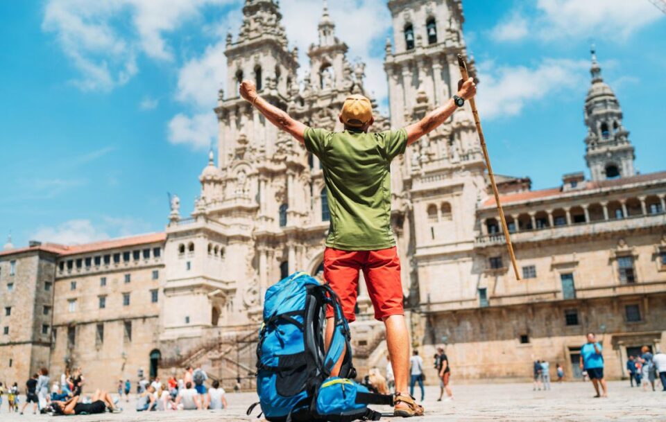 Hiker celebrating completing the Camino de Santiago
