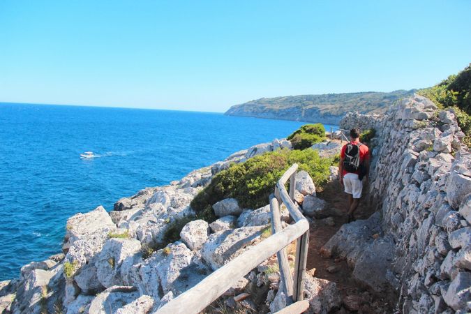 Hiker, Marina Serra, Gagliano del Capo, Puglia, Italy Male hiker on a rocky coastal path alongside the turquoise sea in Puglia, Southern Italy.