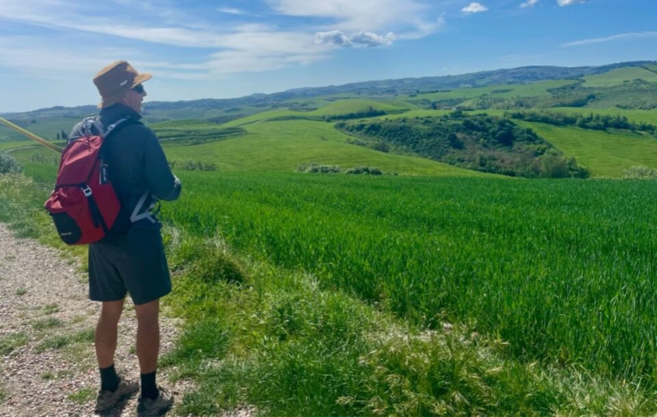 Hiker looking at a stunning vista in Tuscany.