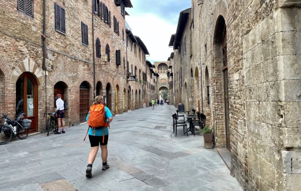 Walker on via Francigena in Tuscany.