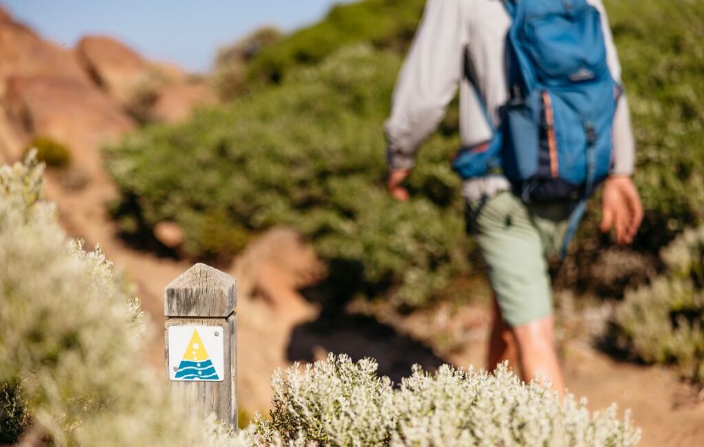 Cape to Cape Track WA Hiker on path with marker