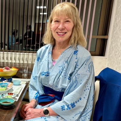 Smiling woman wearing a traditional Japanese yukata, looking at camera