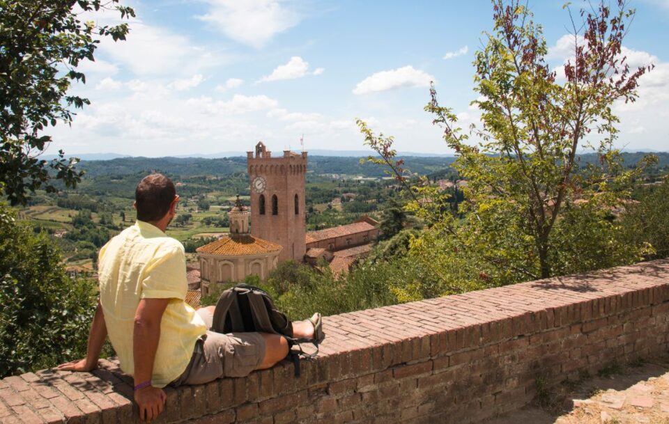 Man relaxing with a view over the impressive landscape in Tuscany near San Miniato in Italy on the Via Francigena