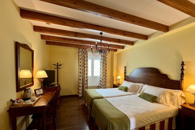 Hotel Virxe da Cerca Santiago in Spain Interior of a historic hotel in Santiago, Spain, with a beamed ceiling, chandelier and ornate furnishings.