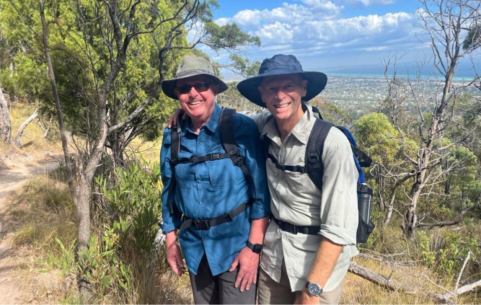 Two male hikers pausing for a rest as they walk up Arthurs Seat on the Mornington Peninsula
