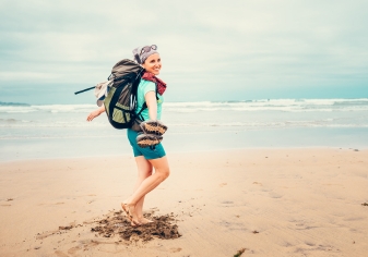 Hiker Spain Camino del Norte Young female hiker on a beach in Spain smiling at the camera