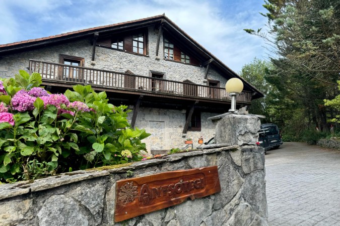 Hotel exterior Camino del Norte Spain Exterior of a rustic stone guesthouse on the Camino del Norte surrounded by greenery.