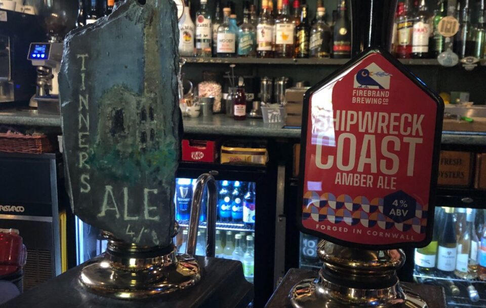 Close up of two beer taps in a pub on the South West Coast Path