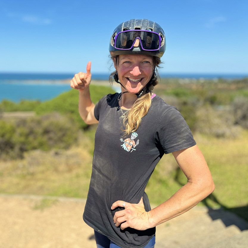 Eve Conyers, RAW Travel's specialist for the European Alps, wearing a bike helmet, waist-up portrait outdoors.