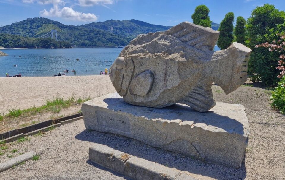 Large stone carving of a fish near the shore of the Seto Inland Sea.
