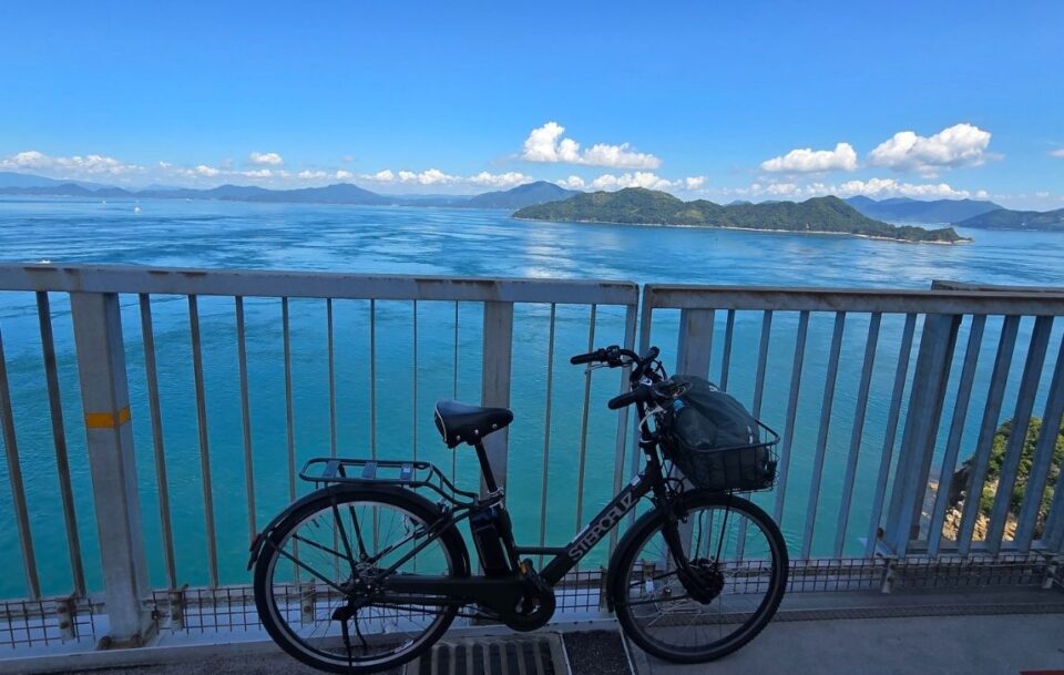 E-bike resting on a metal barrier with stunning views across the Seto Inland Sea