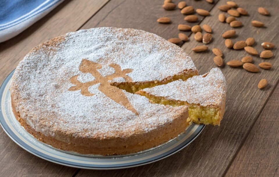 Closeup of the famous Tarta de Santiago almond cake with marked with the iconic cross of a saint.