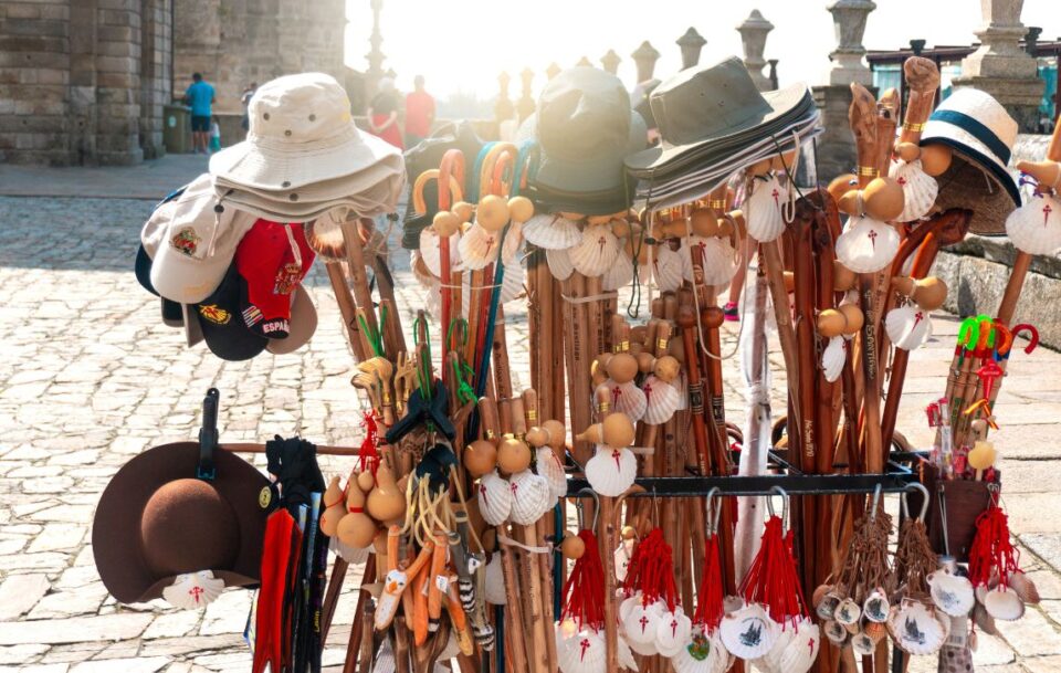 Collection of Camino souvenirs near, including walking sticks, shells and hats, near the Cathedral in Santiago