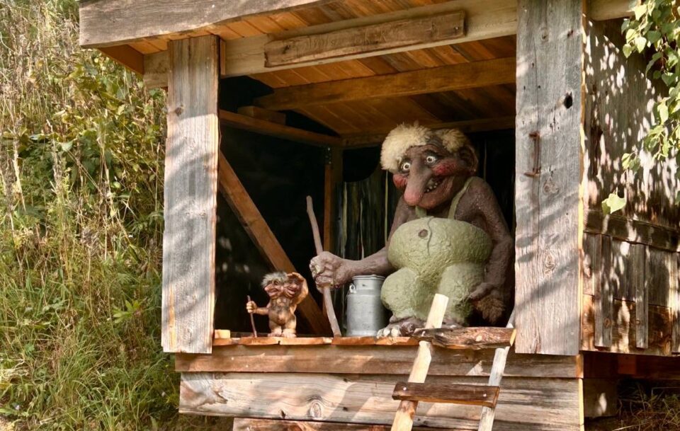 Wooden hut on St Olav’s Way featuring a troll-inspired carving.