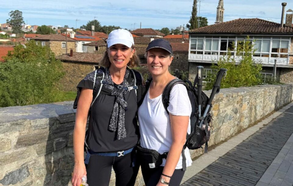 Hikers crossing a bridge on the Camino de Santiago