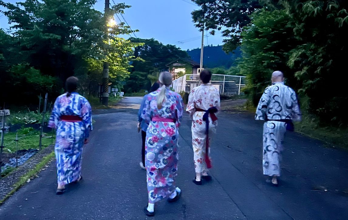 Hikers walking to dinner wearing colorful yukata on the Kumano Kodo