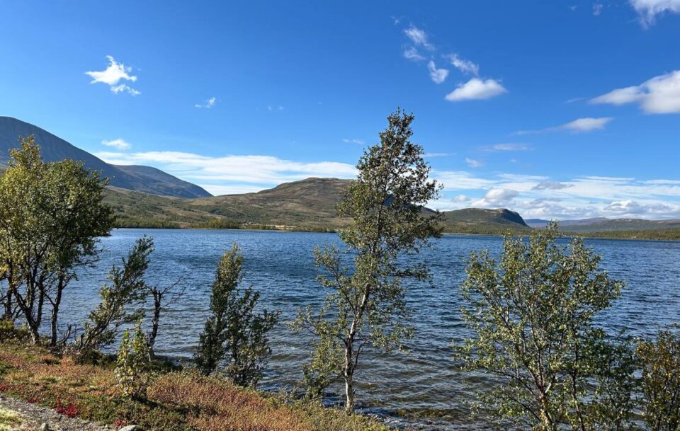 Scenic lake on St Olav’s Way with gentle hills beyond.