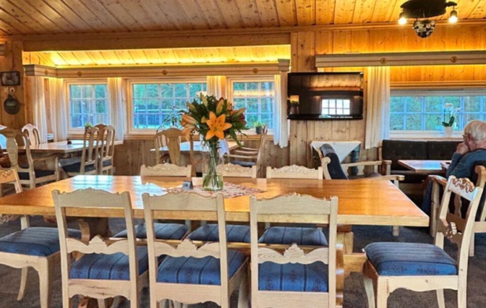 Communal dining room with rustic tables for pilgrims along St Olav's Way.