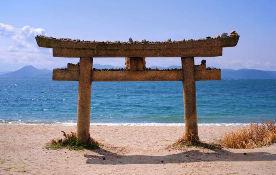 Stone torii gate on beach, Naoshima Island, Japan