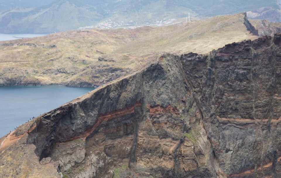 Rocky headland of San Lourenço Peninsula, Madeira with distant hikers giving a sense of scale.