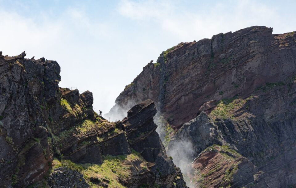 Pico do Areeiro peak with rugged mountain landscape and clouds in Madeira.